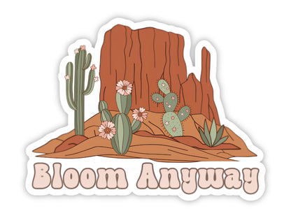 "Bloom Anyway" flower sticker. Red rock buttes with a blooming saguaro, flowering prickly pear, and agave, with the saying in retro pink bubble letters