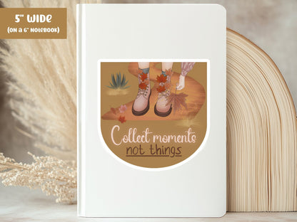 "Collect Moments, Not Things" slow living sticker, 5-inch size, on the cover of a white 6-inch notebook