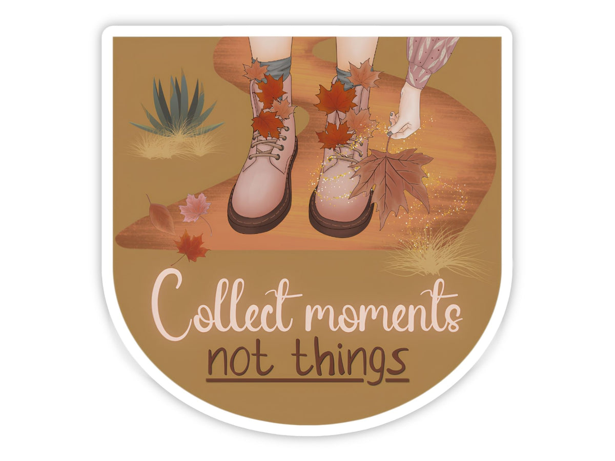 "Collect Moments, Not Things" slow living sticker. Pink lace-up boots on a golden desert path, a hand reaching for a fallen maple leaf, with agave and drifting autumn leaves