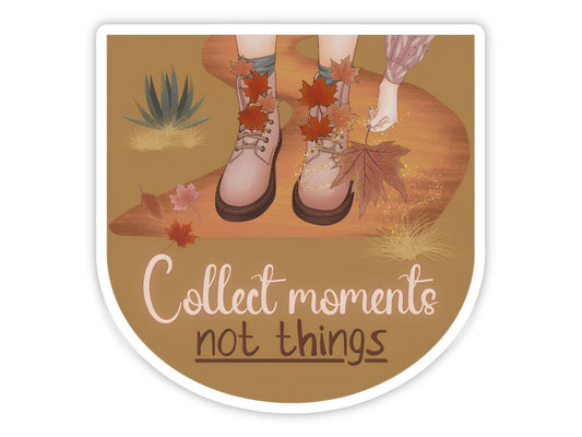 "Collect Moments, Not Things" slow living sticker. Pink lace-up boots on a golden desert path, a hand reaching for a fallen maple leaf, with agave and drifting autumn leaves