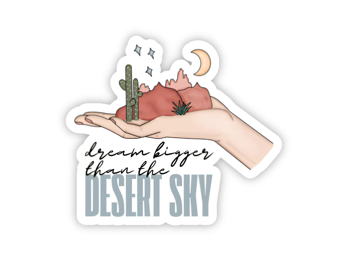 "Dream Bigger Than the Desert Sky" dream big sticker. An open hand holding red rock mountains, a saguaro, a crescent moon, and stars.