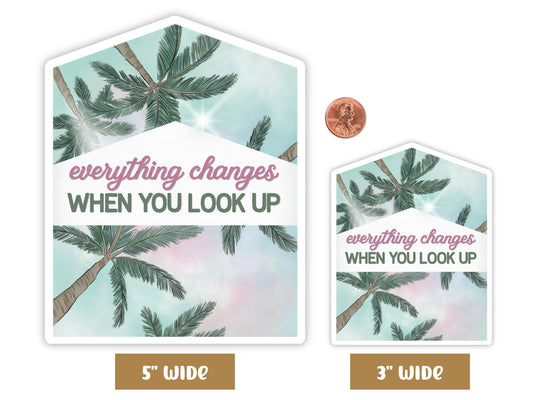 "Everything Changes When You Look Up" palm tree sticker in 5-inch and 3-inch sizes with a penny for scale