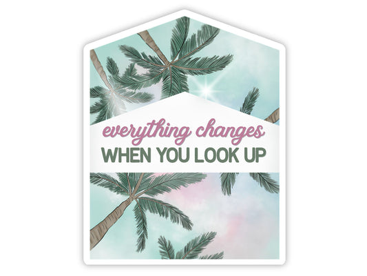 "Everything Changes When You Look Up" palm tree sticker. A house-shaped view straight up through palm fronds into a soft mint and pink sky with a burst of sunlight