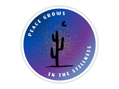 "Peace Grows in the Stillness" meditation sticker. A saguaro silhouette against a starry blue and purple desert night sky, in a round design with the saying curved around the edge
