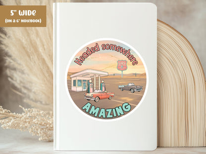 "Headed Somewhere Amazing" retro road trip sticker, 5-inch size, on the cover of a white 6-inch notebook
