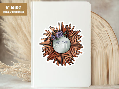 "Stop. Look. Smile." self love sticker, 5-inch size, on the cover of a white 6-inch notebook.